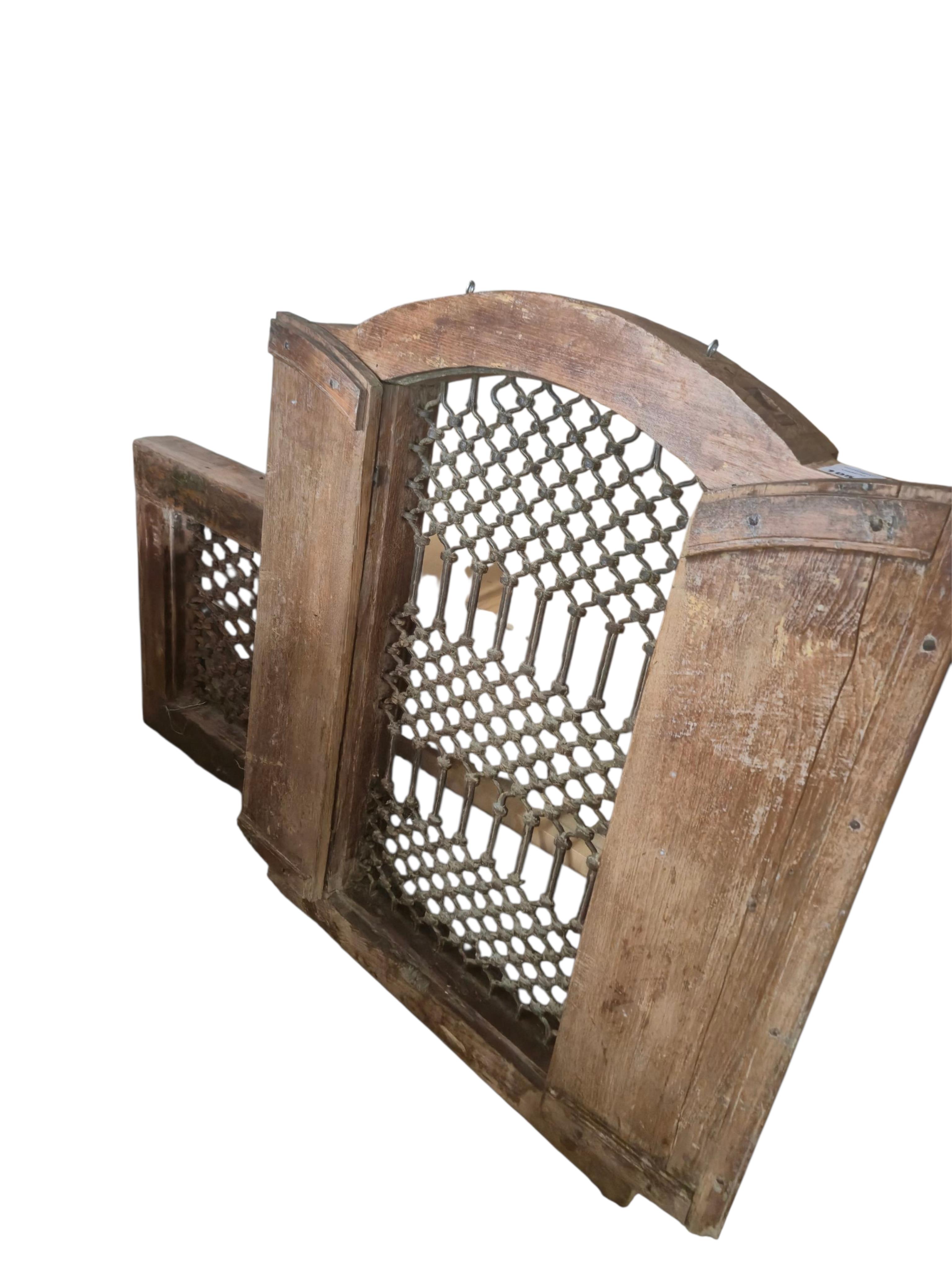 Two Indian hardwood and iron grilled window panels